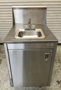 Chefs use a separate hand washing station in their restaurant kitchen 
